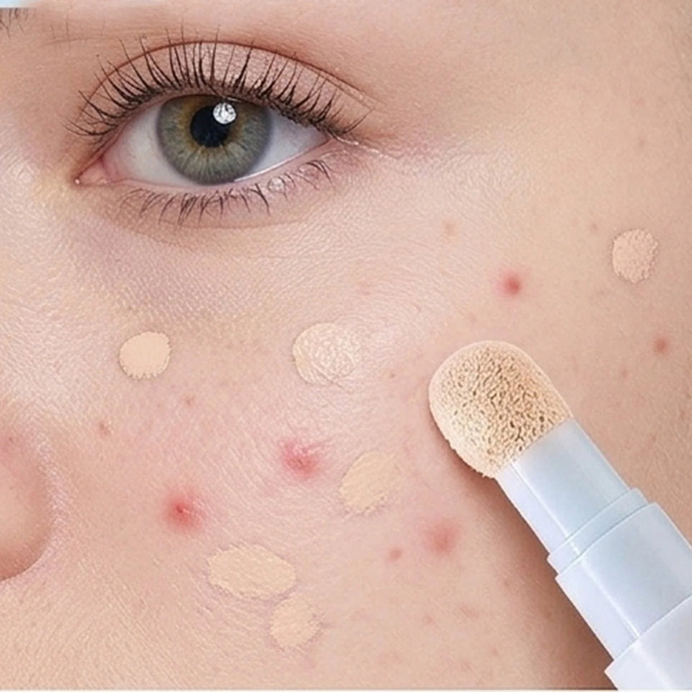 Concealer pen with a soft sponge tip applying coverage to blemishes